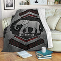 Elephant throw blanket displayed on a sofa with bold industrial black and red artwork
