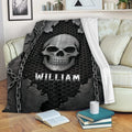Gothic skull throw blanket draped over a couch with chain details and dark industrial artwork