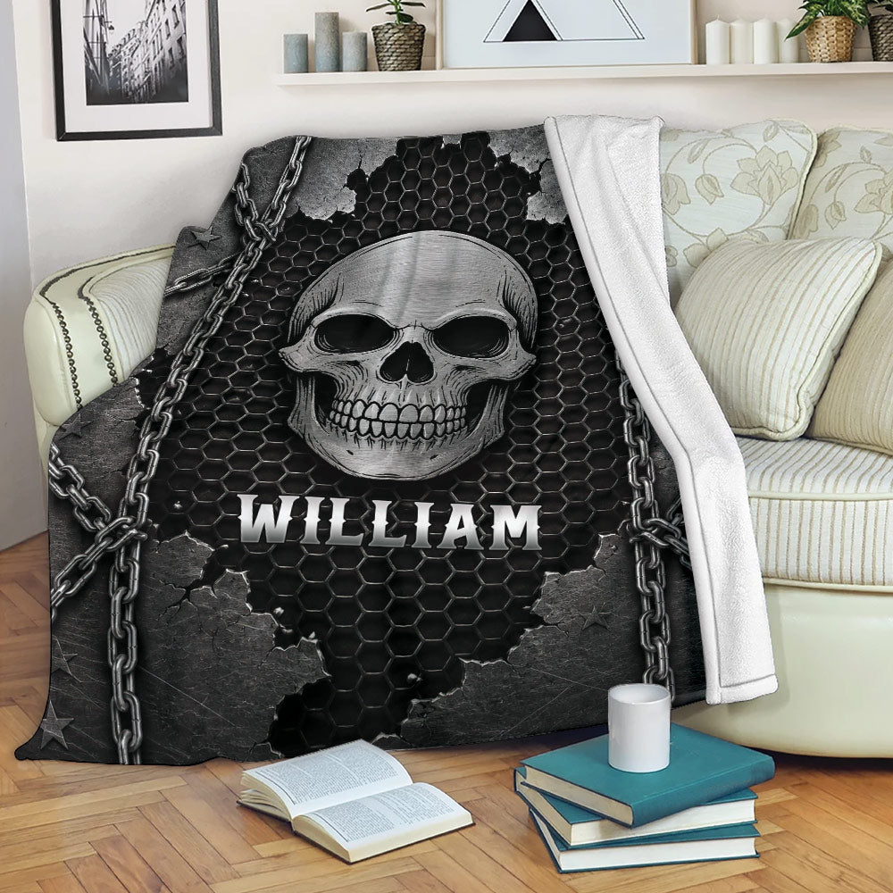Gothic skull throw blanket draped over a couch with chain details and dark industrial artwork