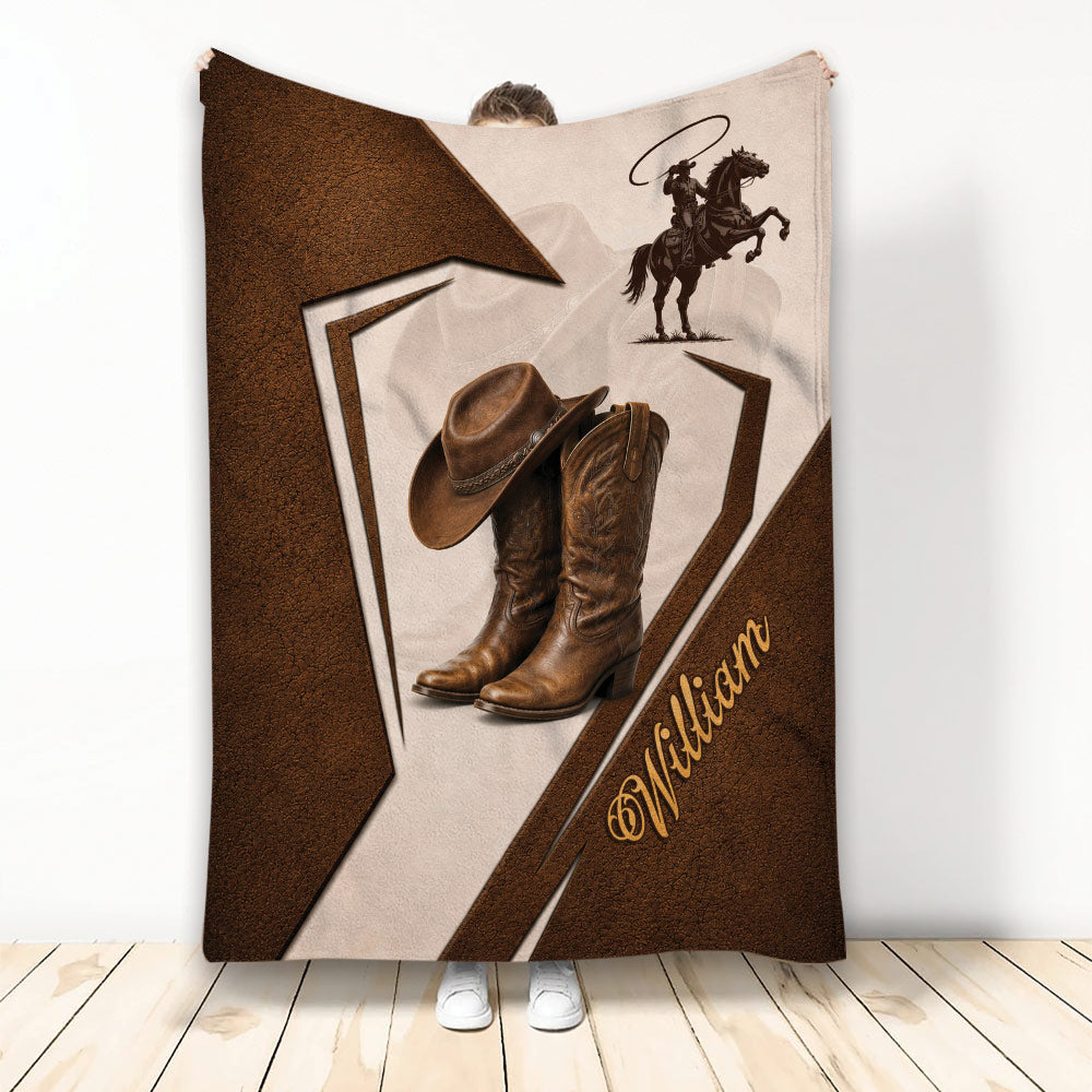 Cowboy throw blanket displayed with western boots, cowboy hat, horseback rider, and rustic brown leather-inspired design