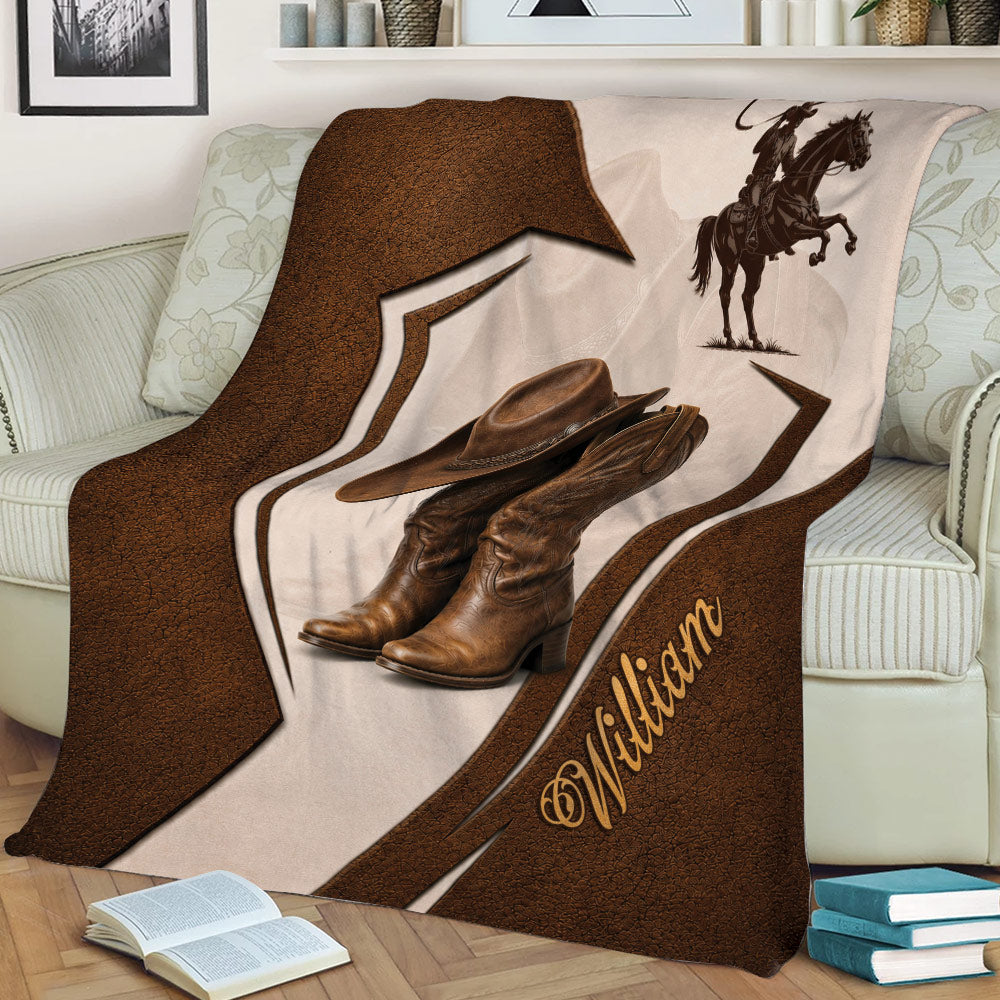 Western cowboy throw blanket styled on a couch with boots, hat, horseback rider, and bold brown decorative accents