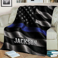 Law enforcement support throw blanket draped over a chair with bold black, silver, and blue artwork