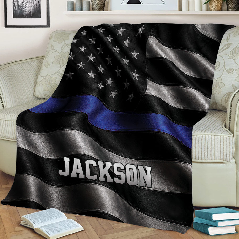 Law enforcement support throw blanket draped over a chair with bold black, silver, and blue artwork