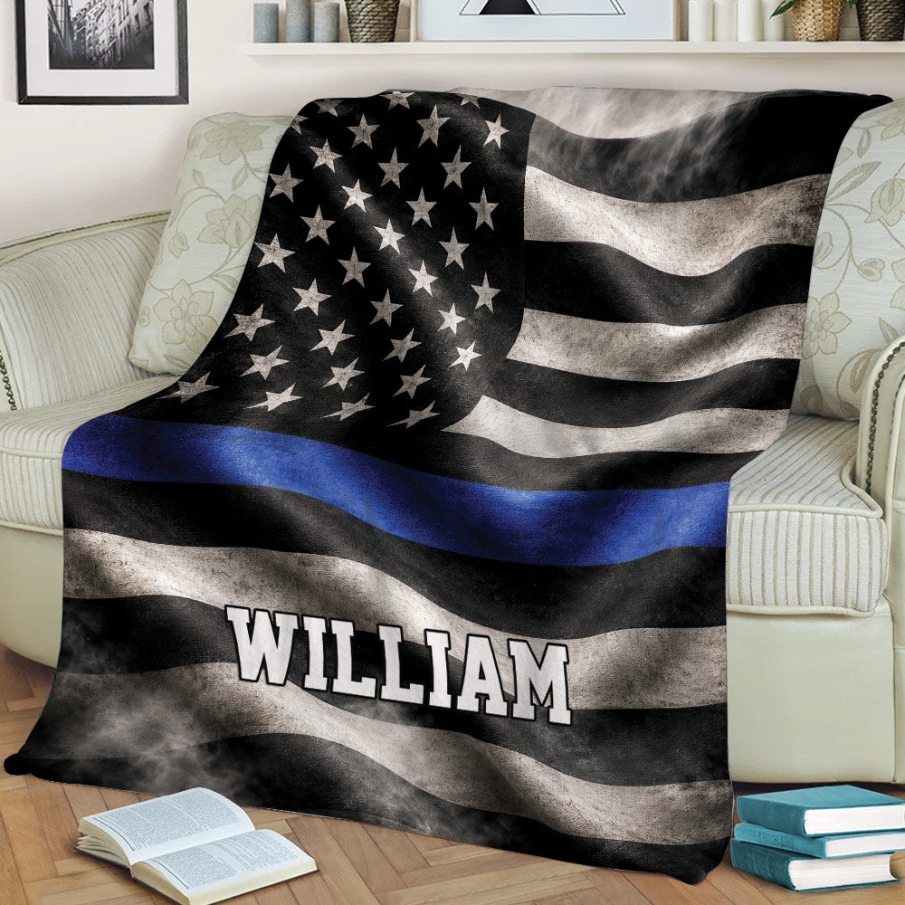 Blue line police throw blanket styled across a sofa with distressed flag artwork