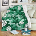 Green camouflage volleyball blanket draped over a sofa in a cozy living room setting