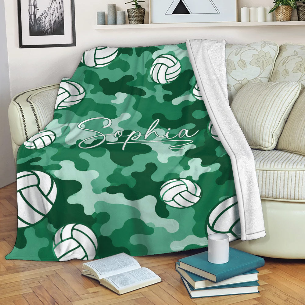 Green camouflage volleyball blanket draped over a sofa in a cozy living room setting