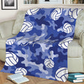 Blue camouflage volleyball blanket spread across a sofa with repeating white volleyball illustrations