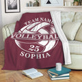 Maroon volleyball throw blanket draped over a sofa with large vintage-style ball artwork