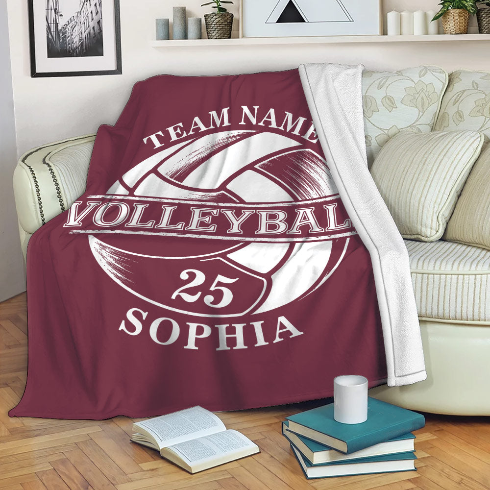 Maroon volleyball throw blanket draped over a sofa with large vintage-style ball artwork