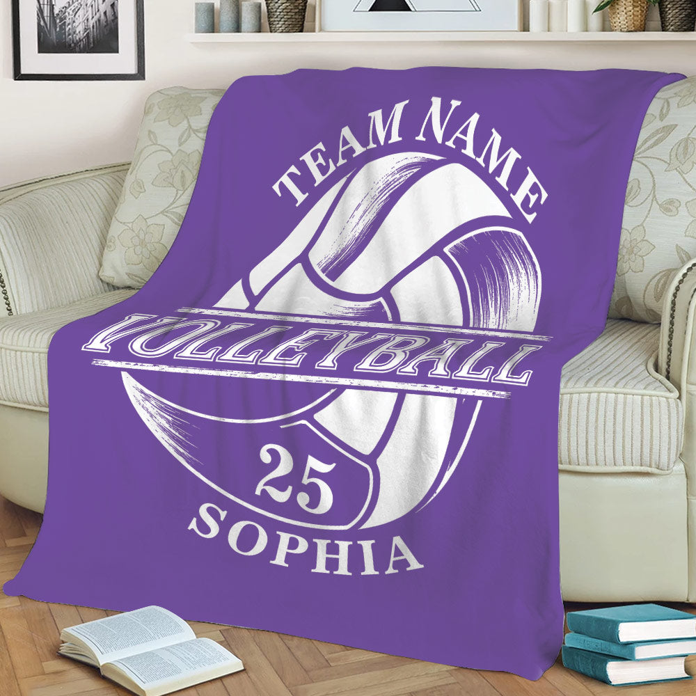 Purple volleyball throw blanket spread across a sofa with oversized ball graphic