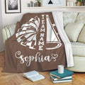 Cheerleading blanket draped over a sofa with bold pom-pom and megaphone design
