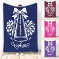 Cheerleading throw blanket with bow, megaphone, pom-poms, lightning bolts, and bold team artwork
