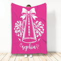 Bright pink cheerleading throw blanket with white bow, megaphone, pom-poms, and lightning bolts