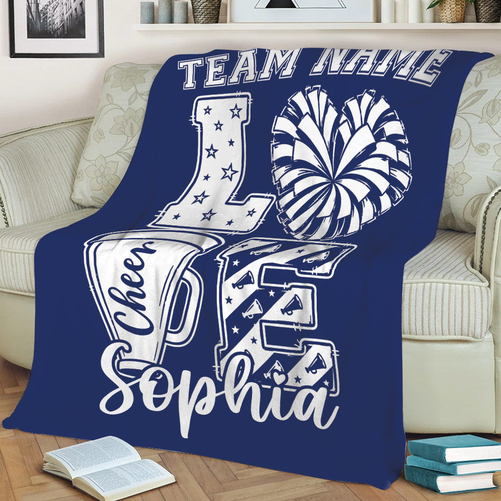 Navy blue cheerleading throw blanket draped over a sofa with energetic cheer artwork
