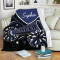 Navy cheerleading throw blanket draped over a sofa with pom-poms and megaphone artwork