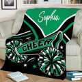 Green cheerleading throw blanket displayed on a sofa with pom-poms, megaphone, and star graphics