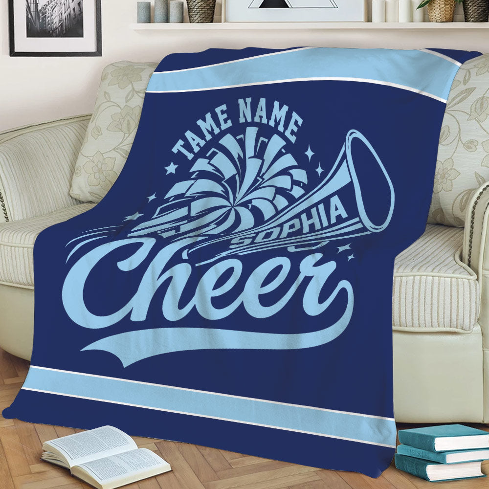 Navy blue cheerleading throw blanket displayed on a sofa with light blue megaphone artwork