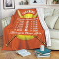 Orange softball throw blanket draped over a sofa with crossed bats and team-themed sports artwork