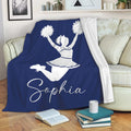Navy cheerleading throw blanket draped over a sofa with a cheerleader silhouette
