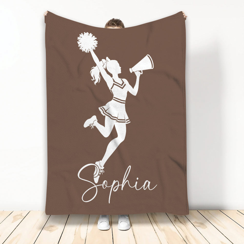 Brown cheerleading blanket featuring a cheerleader silhouette with pom-pom and megaphone