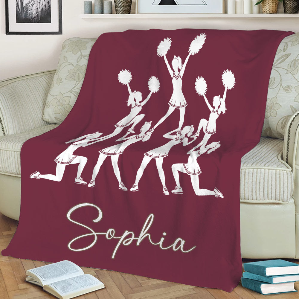 Maroon cheerleading throw blanket with a group of cheerleaders performing together