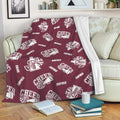 Maroon cheerleading blanket draped over a sofa with repeating cheer megaphone designs