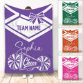 Purple cheerleading throw blanket with bow, pom-poms, megaphone, and team spirit artwork