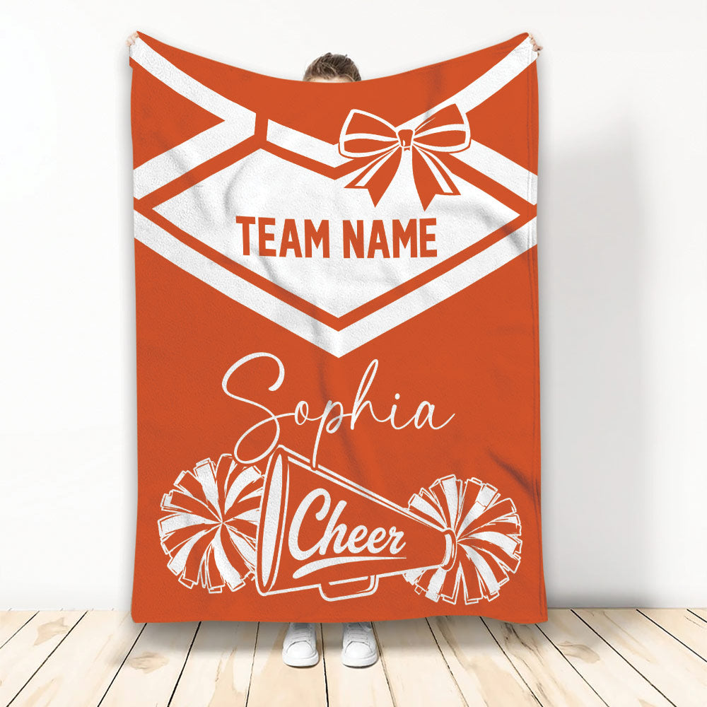 Orange cheerleading throw blanket featuring a bow, pom-poms, and cheer megaphone design