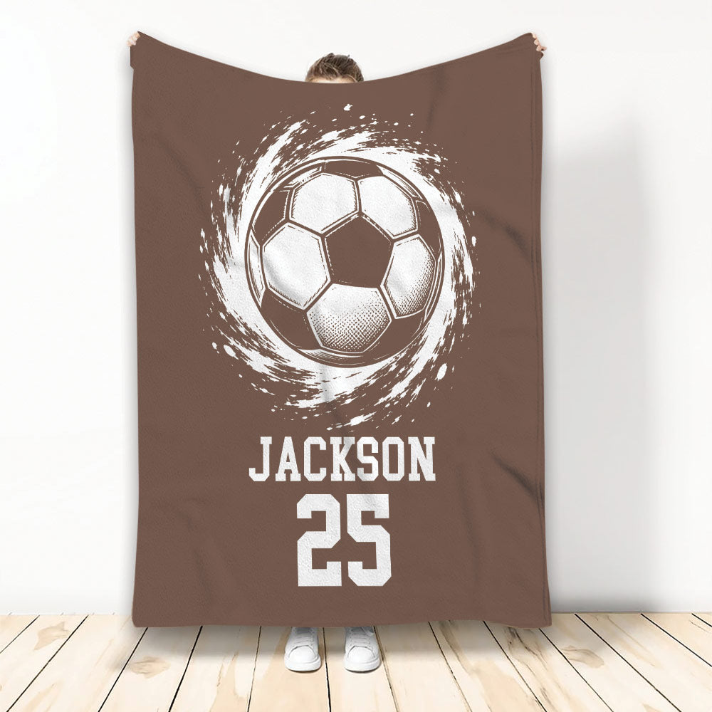 Brown soccer throw blanket featuring a vintage-style ball illustration and bold athletic artwork