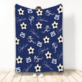 Navy blue soccer blanket with white soccer balls, active player silhouettes, and sporty repeating artwork