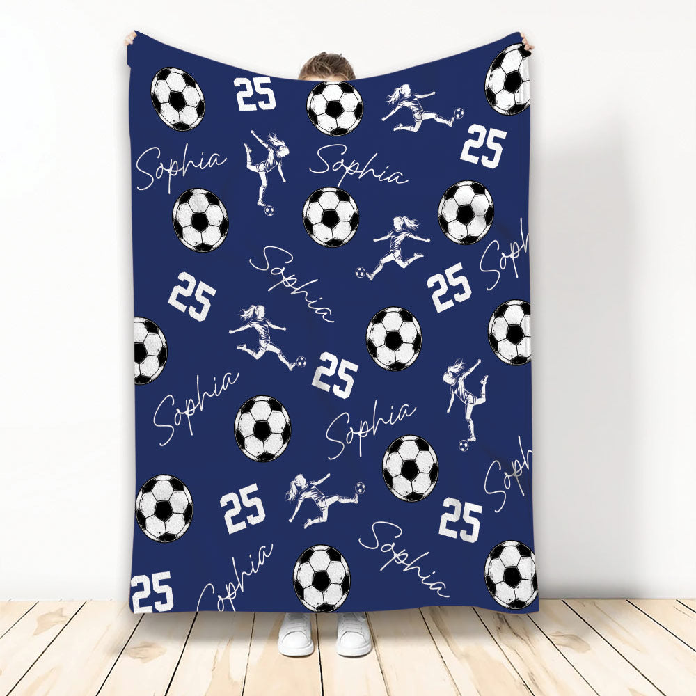 Navy blue soccer blanket with white soccer balls, active player silhouettes, and sporty repeating artwork