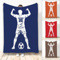 Soccer throw blanket featuring a flexing player silhouette, soccer ball, and multiple color design options