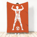 Orange soccer throw blanket featuring a white player silhouette and soccer ball design