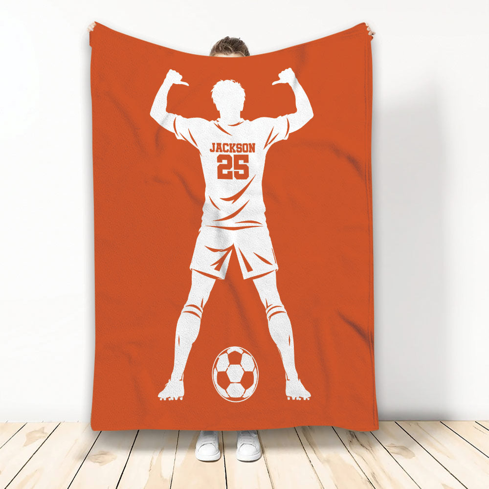 Orange soccer throw blanket featuring a white player silhouette and soccer ball design