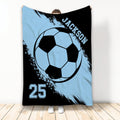 Light blue soccer throw blanket displayed vertically with a large black and blue soccer ball design