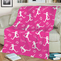 Pink soccer throw blanket styled on a sofa with energetic player silhouettes and repeating soccer balls