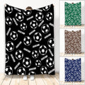 Soccer throw blanket displayed in black, green, brown, and blue color variations with repeating soccer ball artwork
