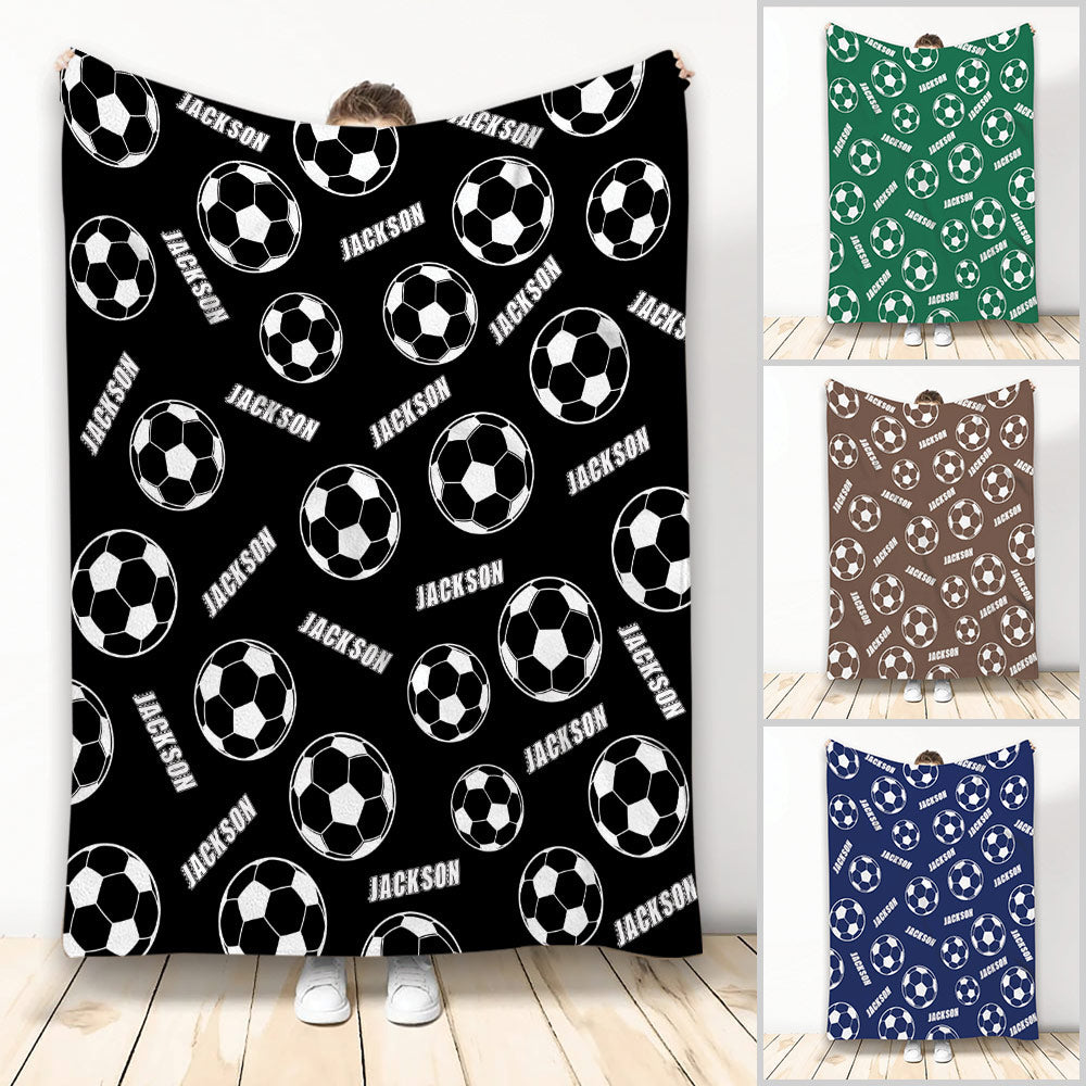 Soccer throw blanket displayed in black, green, brown, and blue color variations with repeating soccer ball artwork