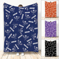 Navy lacrosse throw blanket with repeating sticks, protective helmets, balls, and athletic artwork