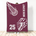 Maroon lacrosse throw blanket featuring a helmet, stick, and bold sports artwork