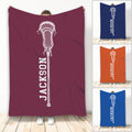 Lacrosse throw blanket displayed in multiple colors with a bold white lacrosse stick design