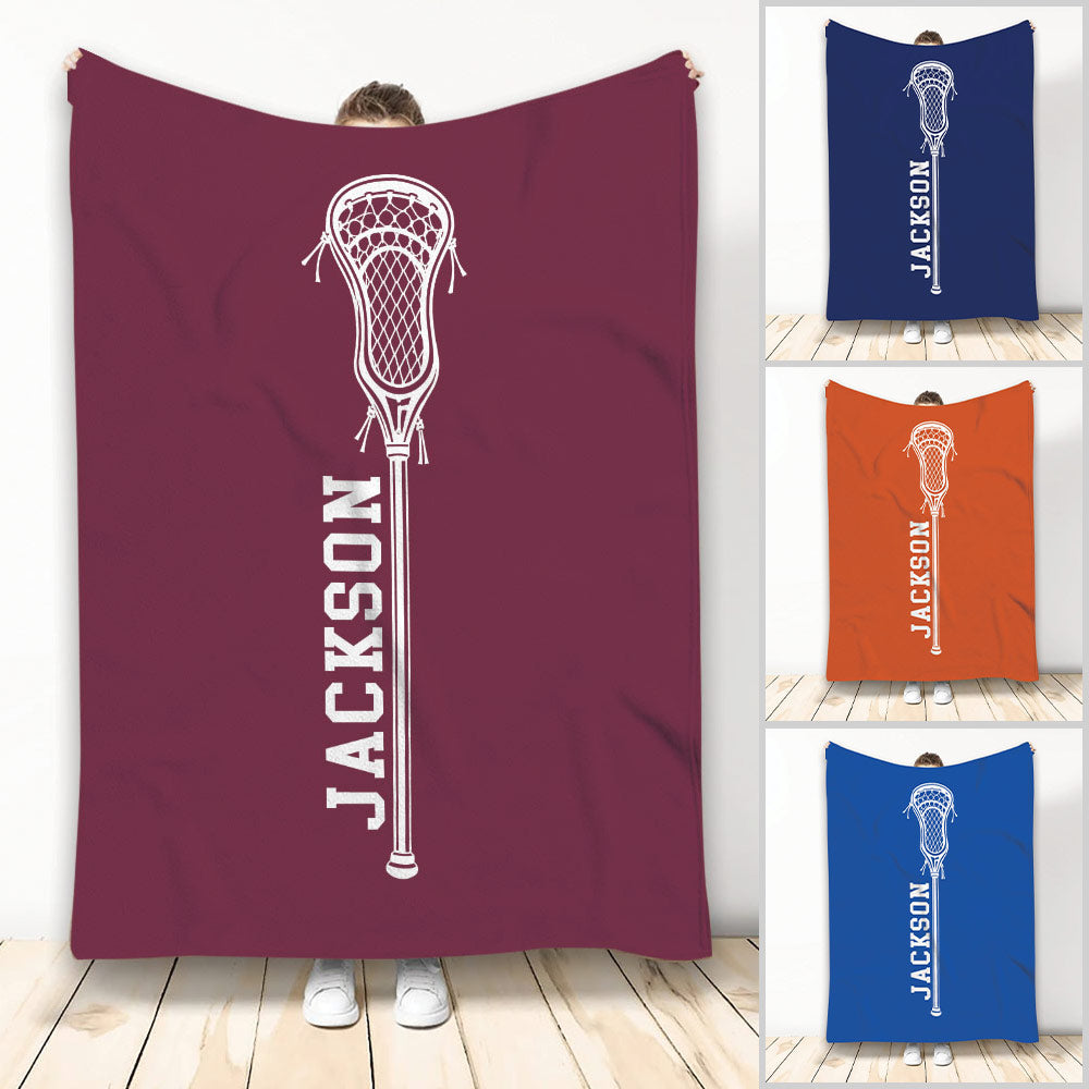 Lacrosse throw blanket displayed in multiple colors with a bold white lacrosse stick design