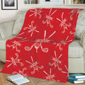 Red golf throw blanket styled on a sofa with crossed golf clubs and golf ball artwork