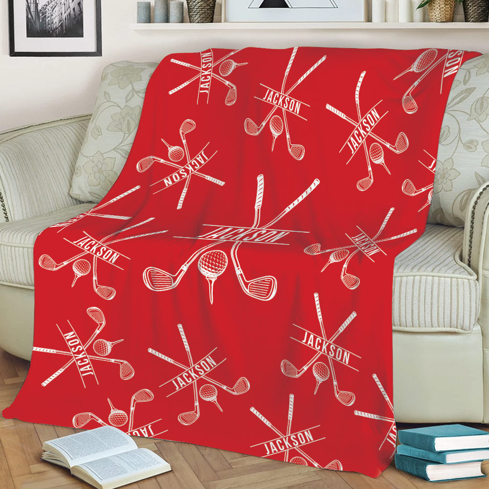 Red golf throw blanket styled on a sofa with crossed golf clubs and golf ball artwork