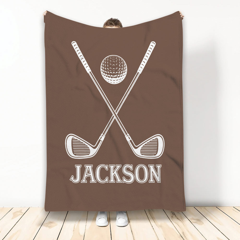 Brown golf blanket with crossed club artwork and a golf ball in a bold white design