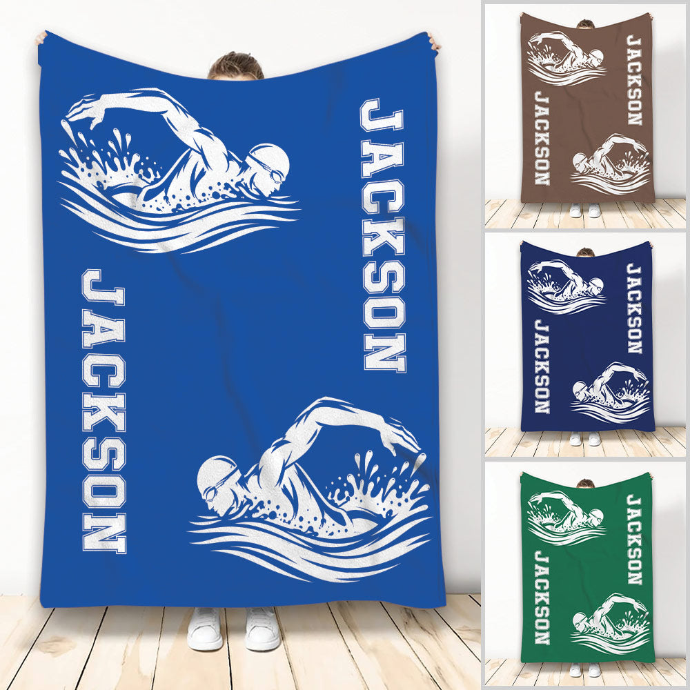 Blue swimming throw blanket featuring two white swimmer silhouettes and bold vertical design text