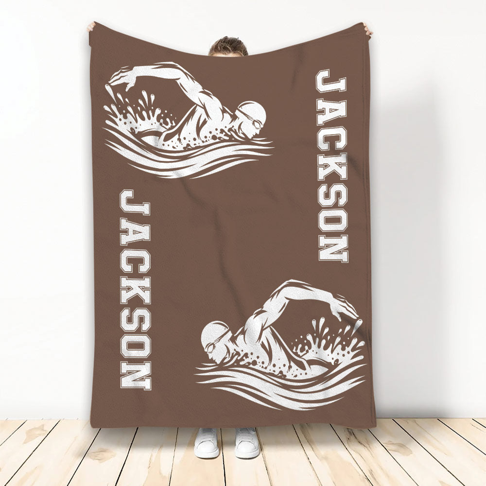 Brown swimming throw blanket displayed upright with two white swimmer silhouettes