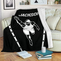 Black swimming blanket draped over a sofa, featuring a bold swimmer illustration