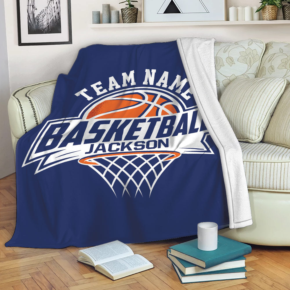 Blue basketball throw blanket displayed on a couch with bold court-inspired graphic artwork