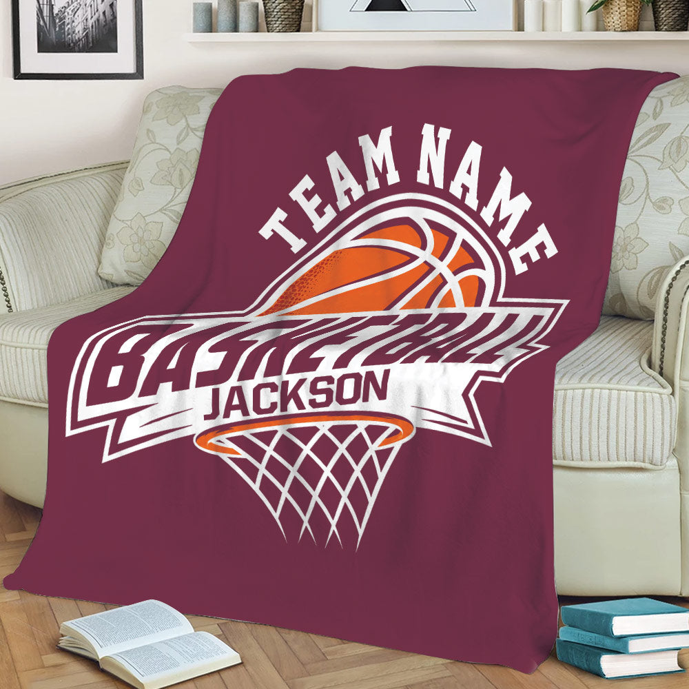 Maroon basketball throw blanket draped over a sofa with bold graphic hoop artwork
